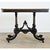 English late 19th century ebonized console or center table that features a variety of angular and curvilinear forms...