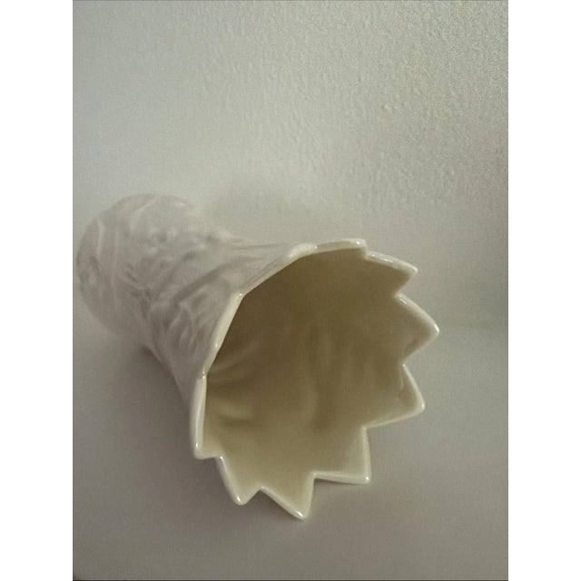 This vintage Belleek "Lily of the Valley" 6 1/2 inch vase is a charming piece of Irish porcelain craftsmanship from the...