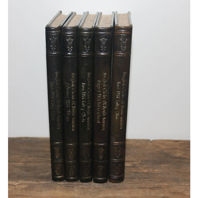 Sets of 5 leather bound Surgical Journals of assorted volumes and publication dates. These beautiful books bound in black...