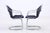 Set of two vintage cantilever chairs by Gastone Rinaldi with an elegantly curved chrome frame and black upholstery. The...