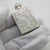 This vintage silver beauty accessory depicts a chiseled scent flask topped with a turquoise colored semi precious stone...