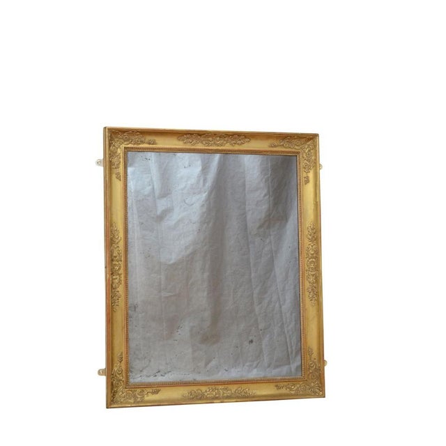 Fine xixth century gilded wall mirror which can be positioned horizontally or vertically, having foxed glass in carved...