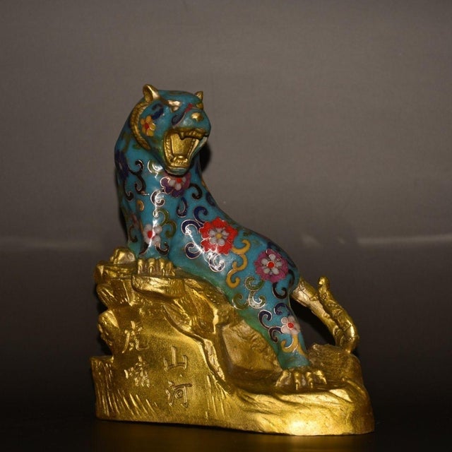 This is a striking antique cloisonné enamel sculpture of a tiger, depicted in a seated, alert posture with its head raised...