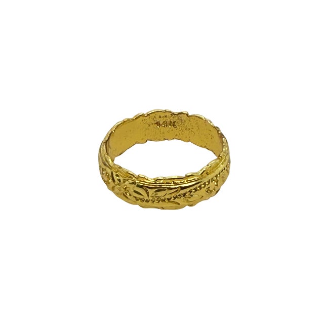 This mid‑century 18K gold band ring features a sculptural floral and vine motif rendered in raised relief, offering both...