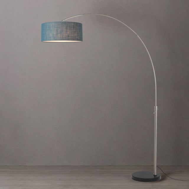 The Float Arc Lamp is a modern arc lamp designed by Peter Morelli in 1960, featuring a satin nickel steel body and a black...