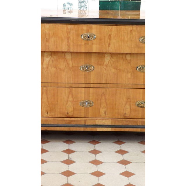 Biedermeier cherry wood chest of drawers with columns, hand-polished around 1830. Very elaborately crafted Biedermeier...