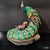 A finely hand-painted ceramic peacock in the Shiwan tradition, shown with its tail spread open, decorated with rich blue,...