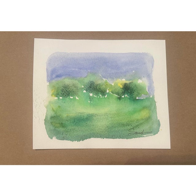A tranquil watercolor interpretation of a summer countryside, where a distant line of trees dissolves softly into a...