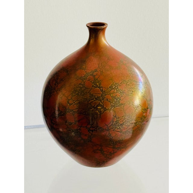 A bronze vase in the murashido technique. Exhibiting the process of splashing oil on the hot bronze to create rich and...