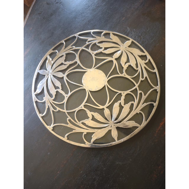 Offered is a large antique sterling overlay trivet. It has a pretty art deco floral design and the center medallion is...