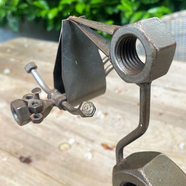 This welded‑steel stork and baby sculpture stands over 24 cm tall and 10 cm wide, and it carries a quiet emotional...
