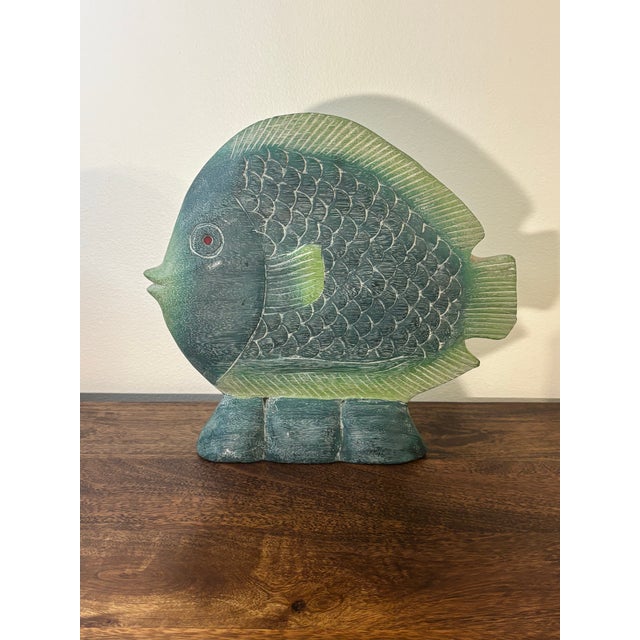 Beautiful and vibrant hand carved wooden fish sculpture. Painted in varying tones of light and dark green then filled with...