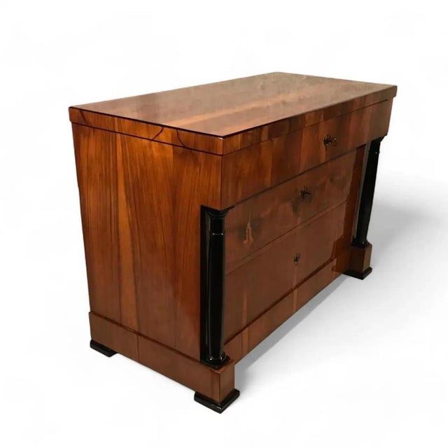 Step into history with our classic Biedermeier chest of drawers, originating from 1820 in South Germany. Crafted with...