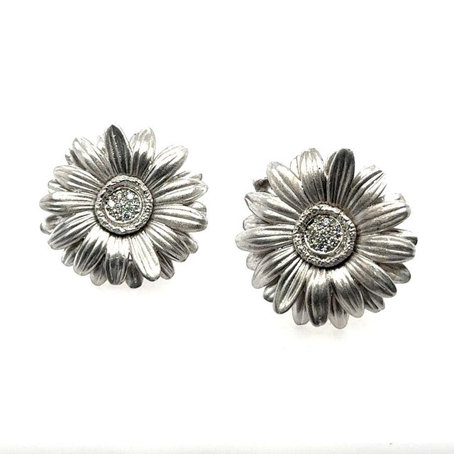Platinum floral style earrings with 14 round diamonds weighing approximately 0.30 carats. 38.34g Signed