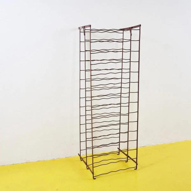 This elegant metal bottle holder is a charming piece of 1960s design, crafted with a slender, wavy structure that combines...