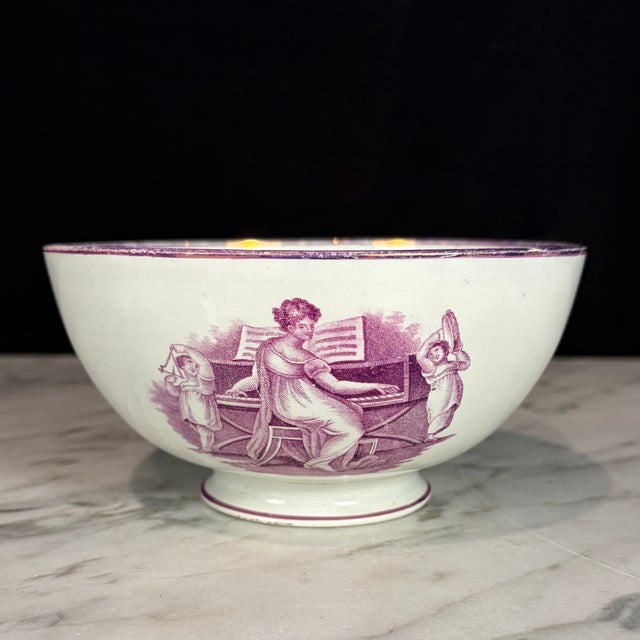 Early 18th-century museum quality English pink lustreware bowl, decorated with delicate scenes depicting a lady seated at...