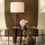 A simple, square body creates a clean canvas for the opulence of rich, luminous burl veneer. Touches of antiqued brass in...
