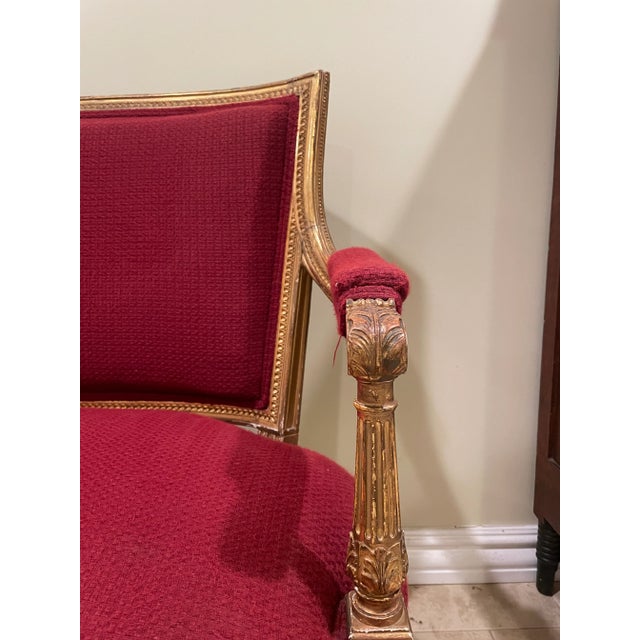 Late 19th Century French Settee with gilded frame with older upholstery but not original to the piece. The lines of the...