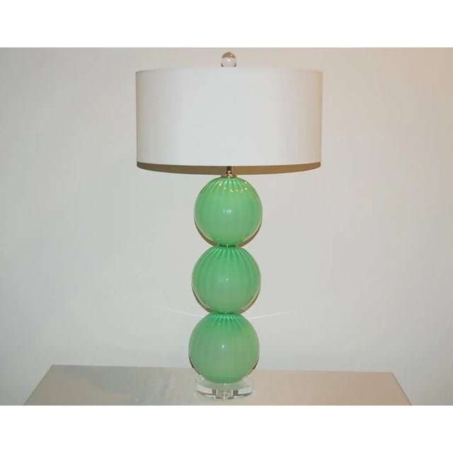 Matched pair of hand blown Three-Ball glass lamps by Joe Cariati in GREEN FROST. Vertical ribs add optical and dimension....
