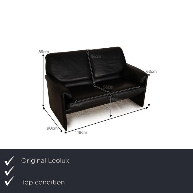 The Bora sofa by Leolux is upholstered in black genuine leather and rests on floor-length side panels. Its minimalist...