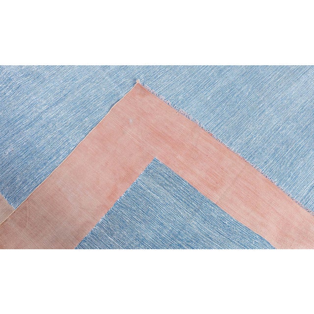 This vintage 1955 Indian Dhurrie rug embodies the quiet elegance and functional beauty characteristic of mid-century flat-...