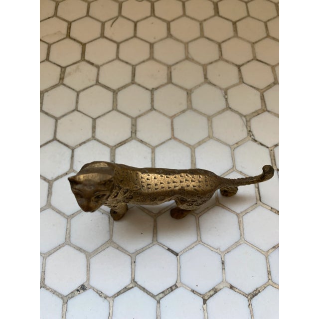 A mid-century, brass leopard statue, this regal cat will add Hollywood Regency charm to any surface! No maker's mark.