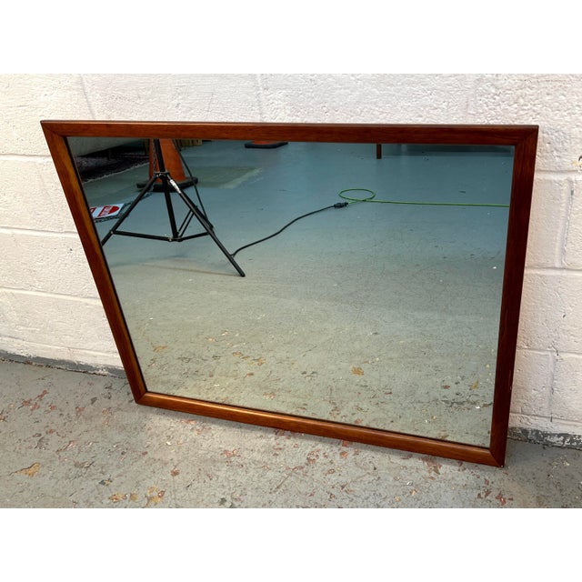 Bring warmth and understated elegance to your space with this authentic Mid-Century Modern (MCM) walnut wall mirror....