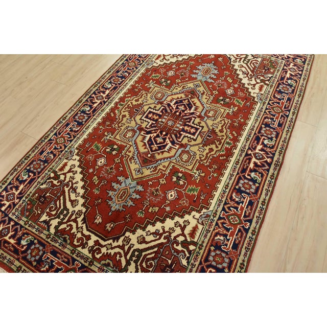 This traditional tribal Serapi rug is hand-knotted with an all-wool pile on a cotton foundation. This rug is new and in...