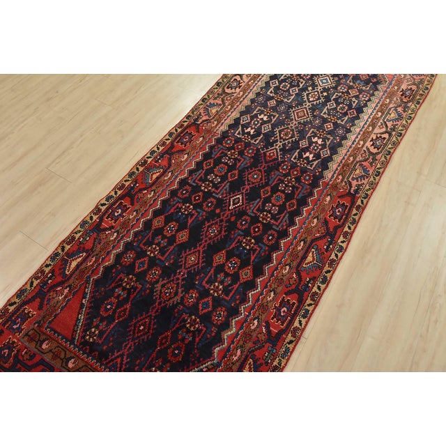 An authentic semi-antique tribal Hamedan runner hand-knotted with fine wool and natural dyes. This nomadic oriental rug...