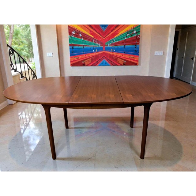 This exquisite teak extending dining table was designed and crafted by a.h. Mcintosh in the 1960s — a true statement piece...