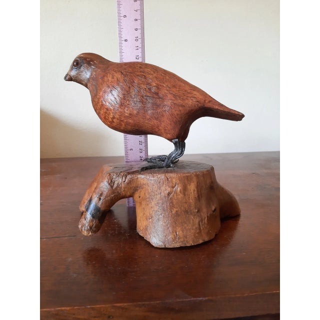 Hand carved folk art bird. Glass eyes and metal feet on wood burl type base. This is a very interesting Arts and Crafts...