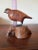 Hand carved folk art bird. Glass eyes and metal feet on wood burl type base. This is a very interesting Arts and Crafts...