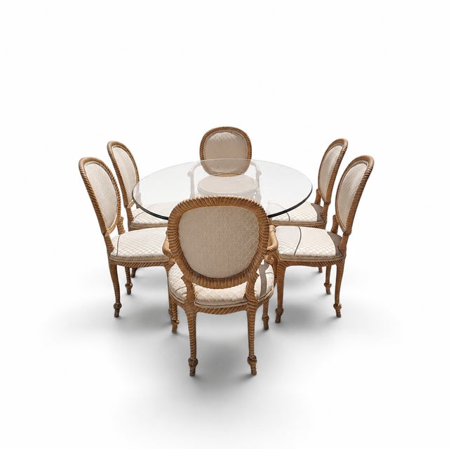 A dramatic vintage dining ensemble centered on an oval half-inch clear-glass top and a sculptural carved wood pedestal....