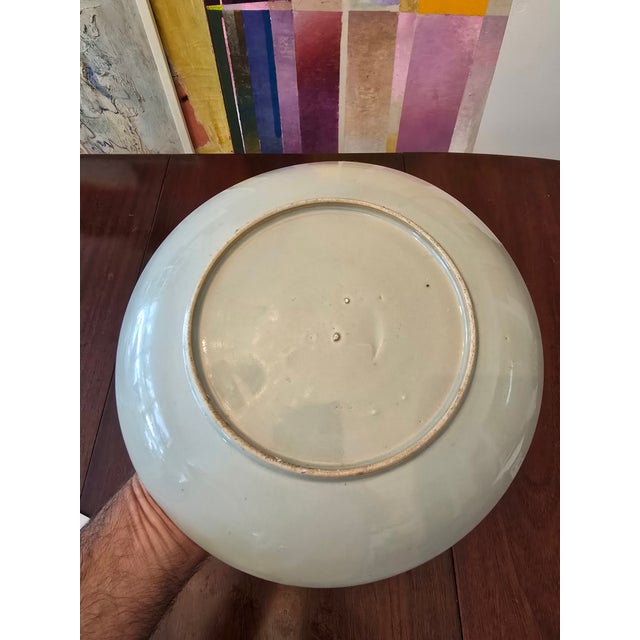 A two hundred years old chinese porcelain plate an antique original with handpainted enamel decoration. In very good...