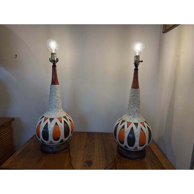 For sale: a stunning pair of mid-century ceramic lamps that will elevate any space! Their unique design and vibrant colors...
