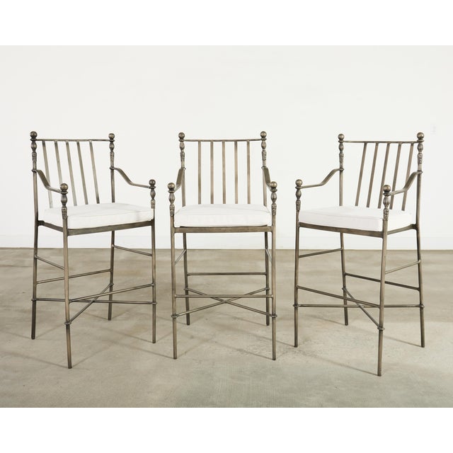 A refined, signed set of three "Montecito" Barstools designed by Michael Taylor (Model #MTD-1080). The stools feature an...