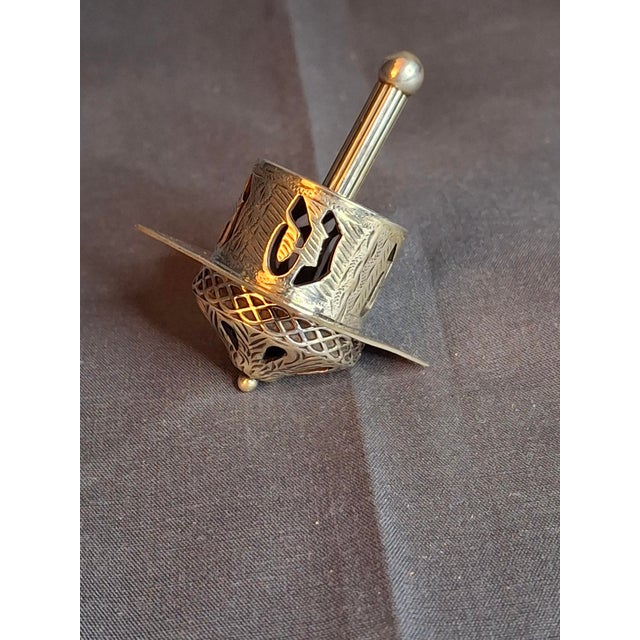 This exquisite collectible dreidel (sevivon) is a masterpiece of Israeli silversmithing. Crafted by the renowned firm...