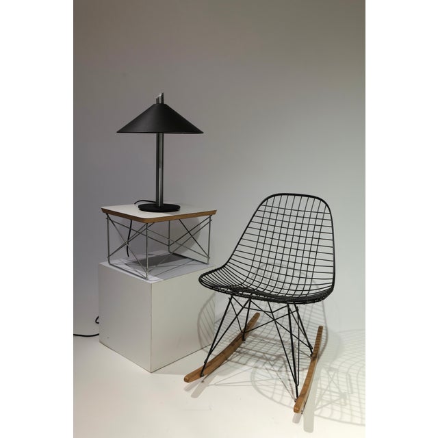 A striking example of postmodern design, this table lamp features a bold, geometric silhouette that balances industrial...