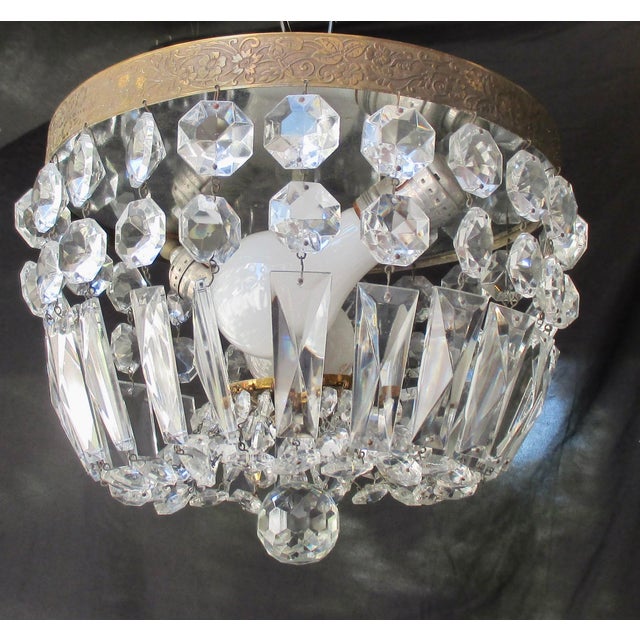 Cut crystal-beaded basket with an embossed Art Nouveau brass ceiling band. The measurements are 10.25" in diameter and...
