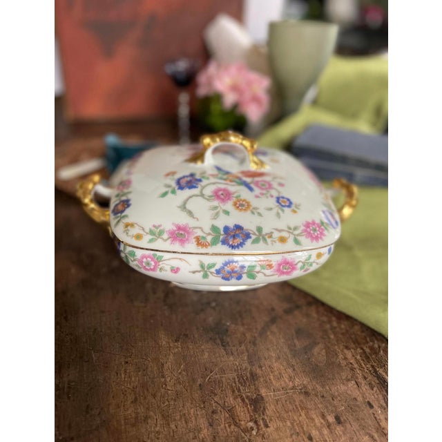 lovely French porcelain lidded serving dish presented in a bird of paradise pattern that is vibrant and colorful. Around...