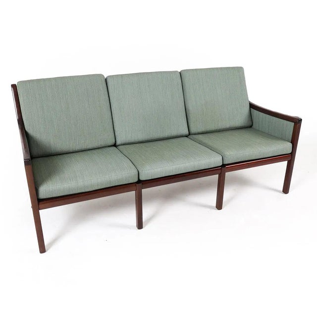 Ole Wanscher For Poul Jeppesen. Modernist upholstery over a rosewood frame. Tagged to frame underneath with both...