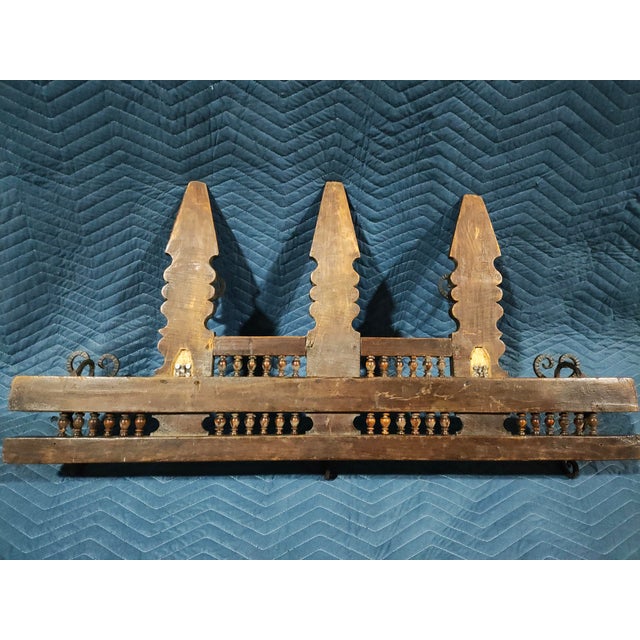 A striking late 19th century Swiss Black Forest Gothic Revival wall rack featuring carved walnut construction and hand-...