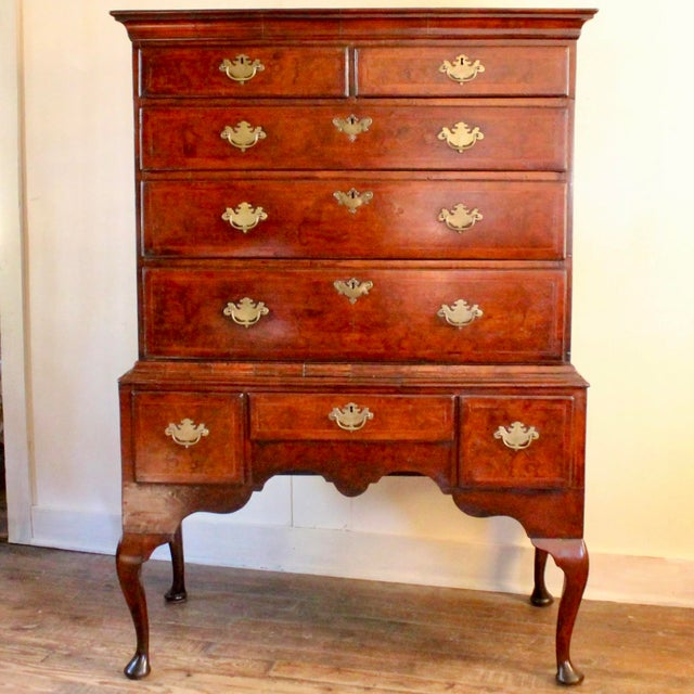 A George I period highboy of fine matched burl walnut timber, herring bone banding and cross-grained moldings, this ca....