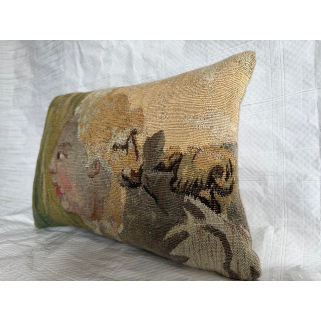 This antique pillow is crafted from a fragment of a 17th century Brussels tapestry, featuring a finely woven figural...