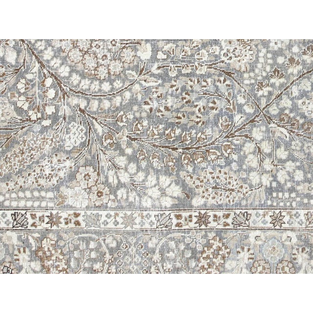 This lavish hand-knotted Persian Tabriz rug adds the perfect touch of elegance to any space. Its intricate design features...
