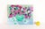 An original acrylic on canvas by North Carolina artist Laura Davis, titled “Violet Roses in Vase.” A colorful floral still...