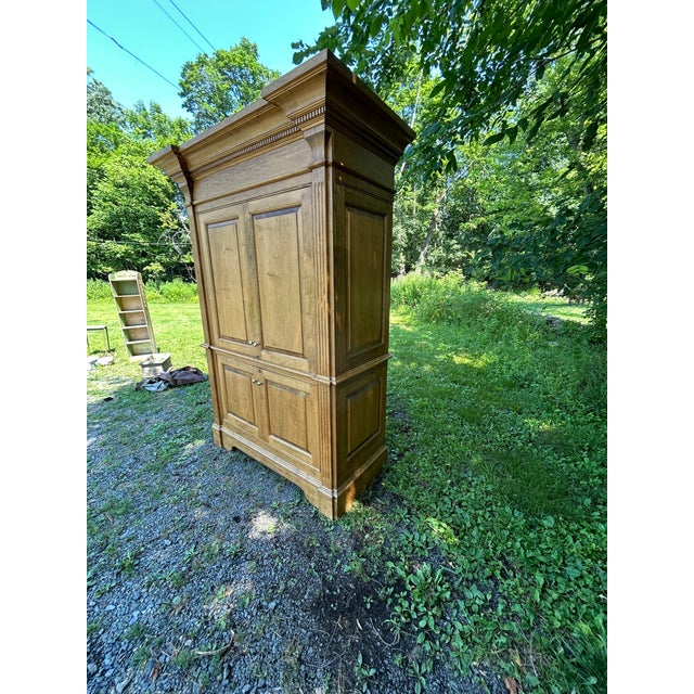 Very impressive monumental in scale armoire cabinet having handsome molding on top and paneling. Two sets of doors open to...