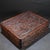 This is a substantial and exquisitely crafted rectangular wooden box, featuring intricate, deep relief carving across its...