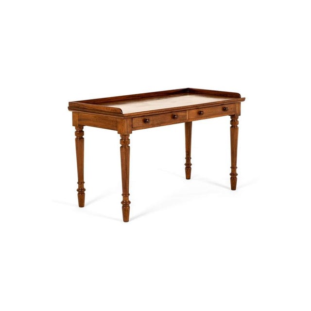A victorian mahogany side or serving table with a shallow rectangular three-quarter gallery. Below a pair of smooth...
