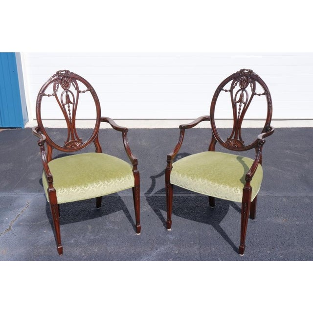 This exceptional set of 12 Adams Style carved mahogany dining chairs, dating to circa 1960s, captures the refined...
